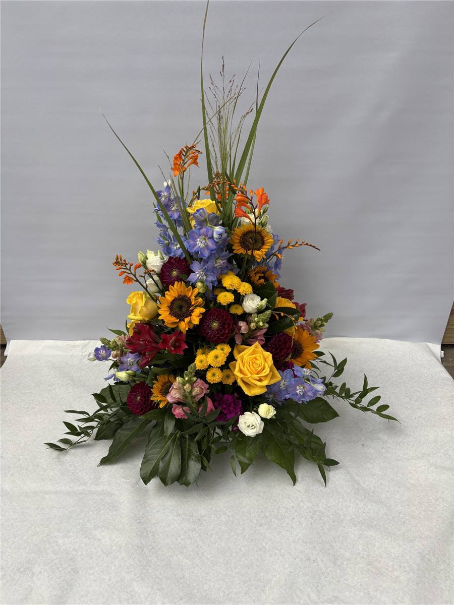 Gesteck mit Sonnenblumen und Gerbera